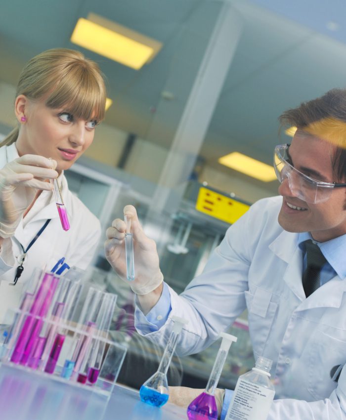 science and research biology chemistry an dmedicine  youn people couple in bright modern  lab