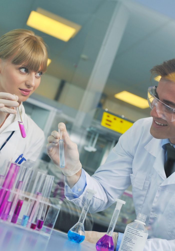 science and research biology chemistry an dmedicine  youn people couple in bright modern  lab