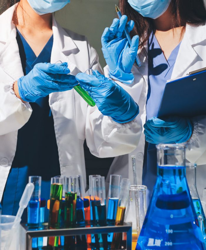 Scientist pipetting medical samples into microplate in laboratory